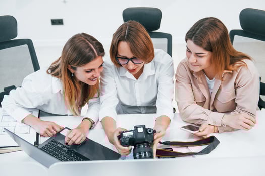 Front view of group of business people in formal clothes working indoors in the office photo
