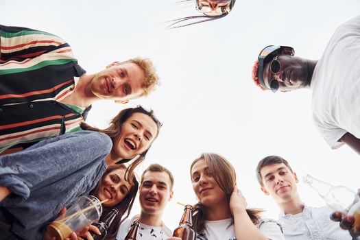 Looking down. View from below. Group of young people in casual clothes have a party at rooftop together at daytime photo