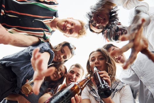 Looking down. View from below. Group of young people in casual clothes have a party at rooftop together at daytime photo