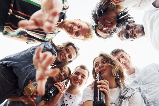 Looking down. View from below. Group of young people in casual clothes have a party at rooftop together at daytime photo