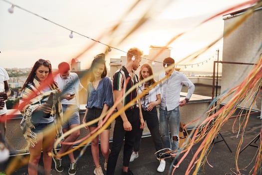 Group of young people in casual clothes have a party at rooftop together at daytime photo