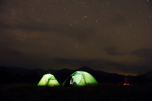 Green tents at night time. Starry sky. Majestic Carpathian Mountains. Beautiful landscape of untouched nature photo