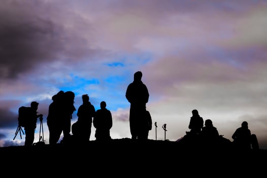 A group of trekkers black silhouette in the cloudy sky background photo