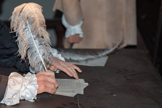 hand writing a letter with a plume photo