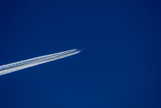 jet airplaine wakes on blue sky photo