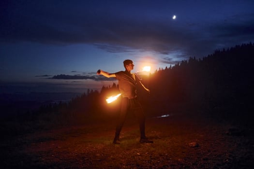 Man doing a fire show at night outdoors photo