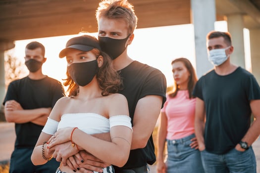 Couple embracing each other. Group of protesting young people that standing together. Activist for human rights or against government photo