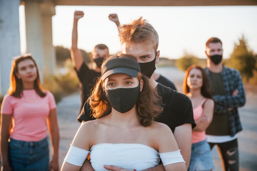 Couple embracing each other. Group of protesting young people that standing together. Activist for human rights or against government photo