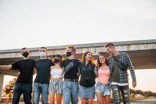 Embracing each other. Group of young cheerful friends having fun together. Party outdoors photo
