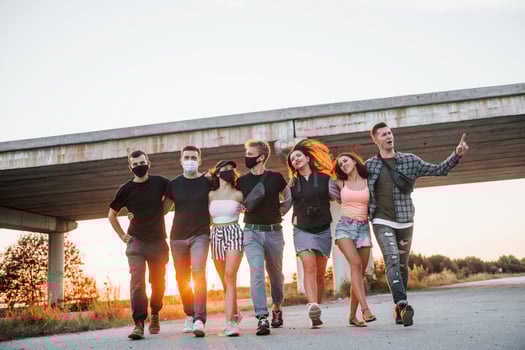 Embracing each other. Group of young cheerful friends having fun together. Party outdoors photo
