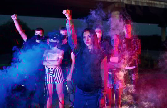Smoke, fists, police. Group of protesting young people that standing together. Activist for human rights or against government photo