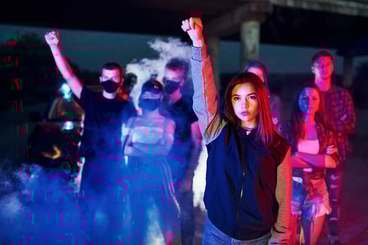 Smoke, fists, police. Group of protesting young people that standing together. Activist for human rights or against government photo
