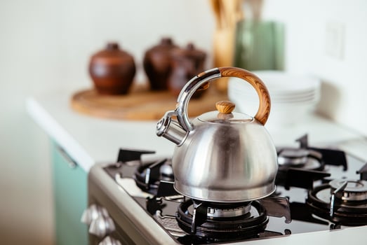 Kettle on the gas stove. Interior of modern kitchen photo