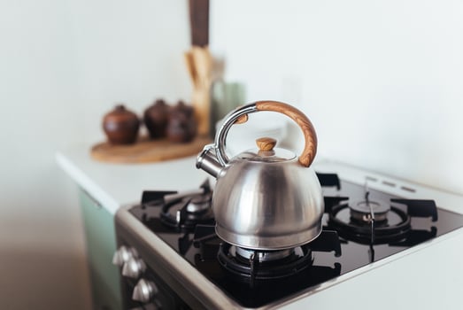 Kettle on the gas stove. Interior of modern kitchen photo