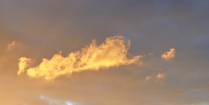 Beautiful panorama of orange and yellow clouds at sunrise photo