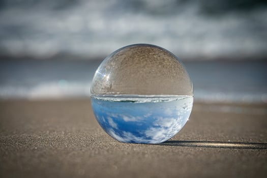 Glass globe on the beach of the Baltic Sea in Zingst in which the landscape is depicted. photo