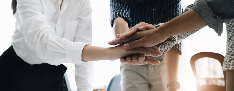 Close up young business people putting their hands together. Stack of hands. Unity and teamwork concept. photo