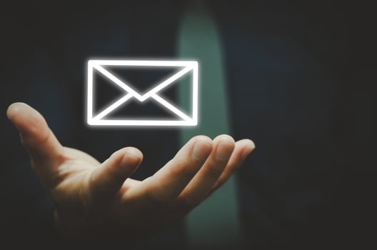 businessman holding email icon Contact us by email newsletter. and protect your personal information from spam. Customer Service Center Contact us Concept. photo