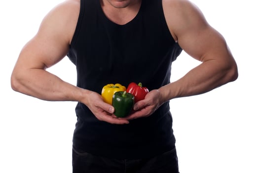Raw food man holding vegetables and fruit photo