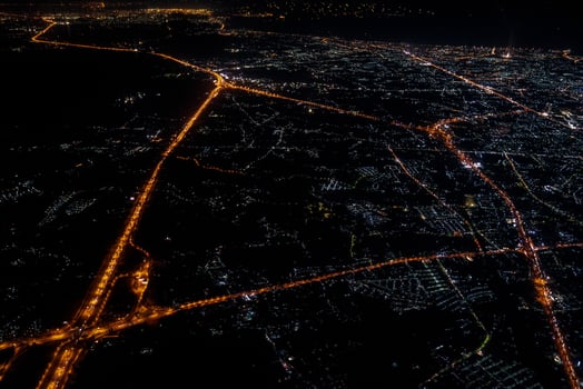 Night view from the jetplane in twilight time with the red sky and light of the city. photo