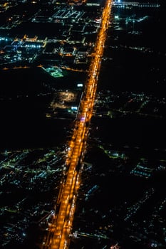 Night view from the jetplane in twilight time with the red sky and light of the city. photo
