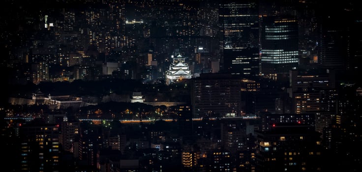 Osaka Castle illuminated at night in panorama  birdeye or top view with cityscape and high building around, Osaka Prefecture, Japan. photo