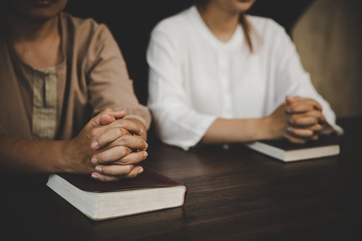 Two women praying worship believe photo