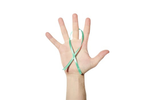 Green awareness ribbon in hand photo
