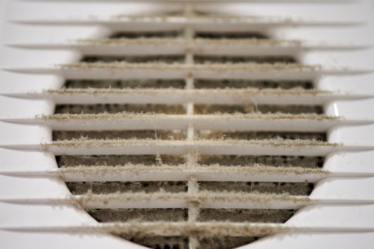Dirty air ventilation grill of HVAC with clogged filter. photo