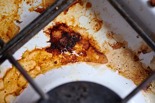 Dirty stove with food leftovers photo