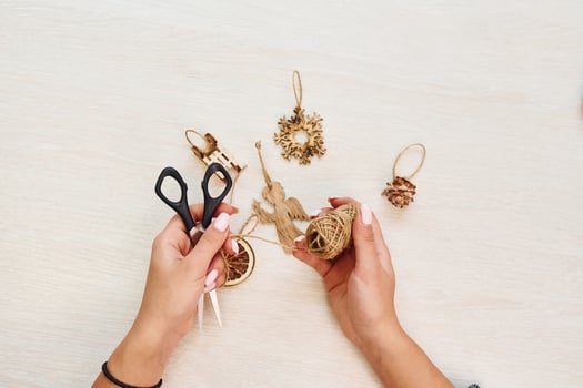 Woman's hands holds toys. Top view of christmas festive texture with new year decorations photo