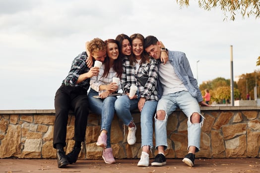 Coffee time. Group of young cheerful friends that is outdoors having fun together photo