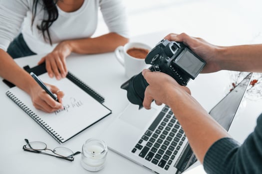 Photographer at work. Two young female freelancers indoors in the office at daytime photo