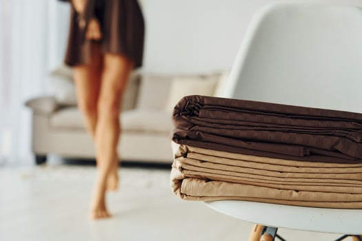 Blur view of woman near bed clothes. Interior and design of beautiful modern bedroom at daytime photo