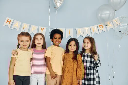 Posing for the camera. Children on celebrating birthday party indoors have fun together photo