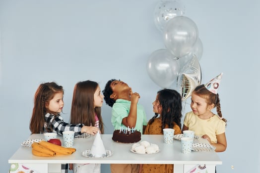 Holiday cake. Children on celebrating birthday party indoors have fun together photo