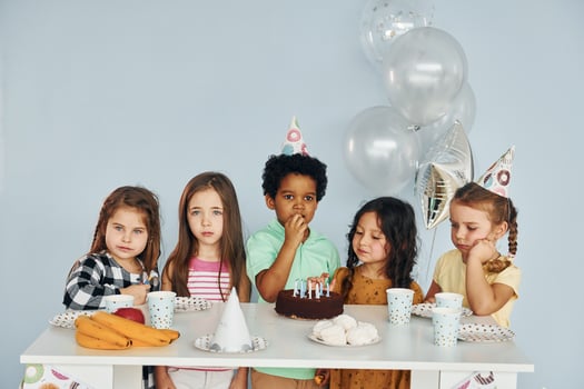 Holiday cake. Children on celebrating birthday party indoors have fun together photo