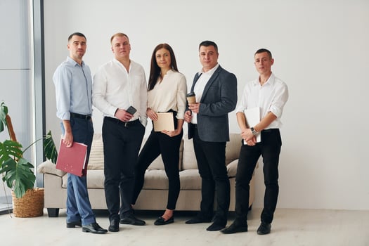 Group of office workers in formal official clothes is together indoors photo