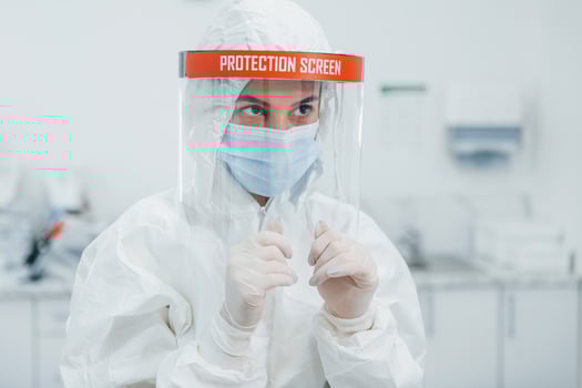 Female medical worker in protective uniform works on COVID-19 vaccine photo