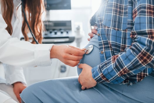 Pregnant woman is in the clinic in cabinet and have health check photo