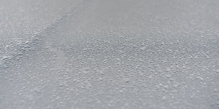 Raindrops on the hood of the car. Close-up. photo