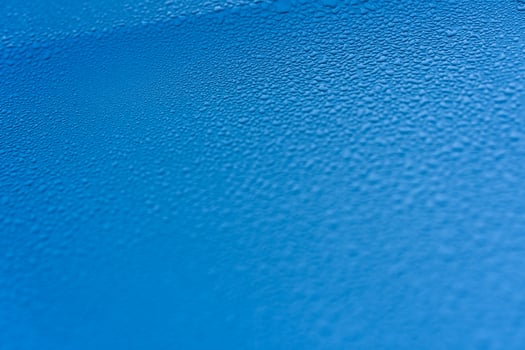 Raindrops on the hood of the car. Close-up. photo