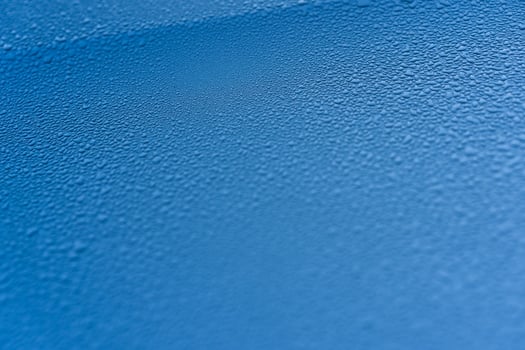 Raindrops on the hood of the car. Close-up. photo