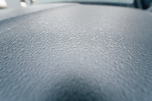 Raindrops on the hood of the car. Close-up. photo