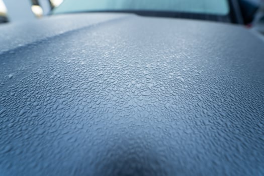 Raindrops on the hood of the car. Close-up. photo