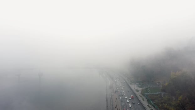 A city covered in fog. City traffic, aerial view photo