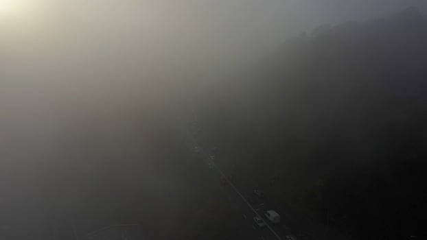 A city covered in fog. City traffic, aerial view photo