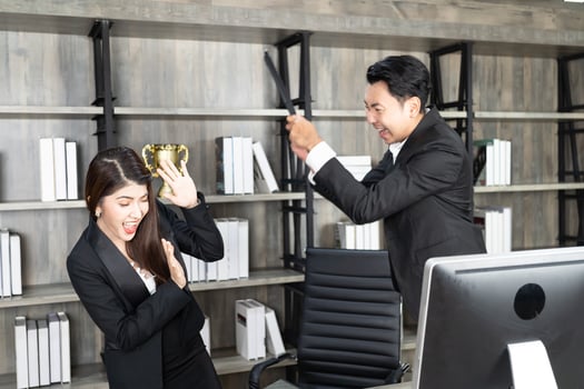 Emotional colleagues fighting in office. Workplace conflict. Angry boss. Man as a boss in the office is violent against a woman as an employee photo