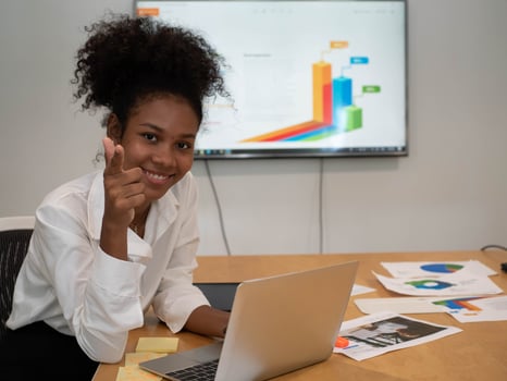 Businesswoman manager african person hair fashion lifestyle  work job career happy smile laptop notebook computer technology financial stock marketing Female is sitting cheerful look at camera photo