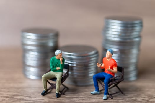 Miniature people A businessman is seated atop a mound of money photo